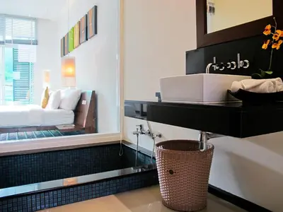a bathroom with a sink and a bed in a mirror at Villa 4 Bedrooms with private pool at Oxygen Bangtao in Bang Tao Beach