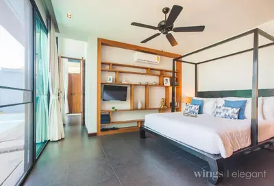 a bedroom with a bed and a ceiling fan at Villa 1 Bedroom with private pool at Wings Pasak in Bang Tao Beach