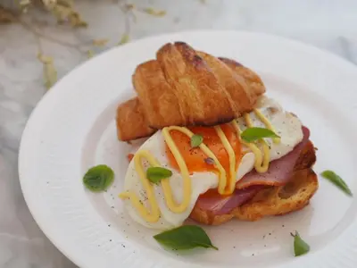 a white plate with a sandwich with eggs and toast at Villa 3 Bedrooms with private pool at Wings Pasak in Bang Tao Beach