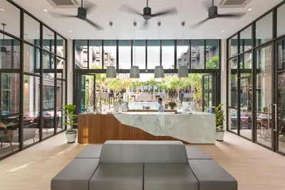 a lobby with a reception desk and windows at Saturdays Residence - 1 Bedroom Service Apartment in Rawai Beach