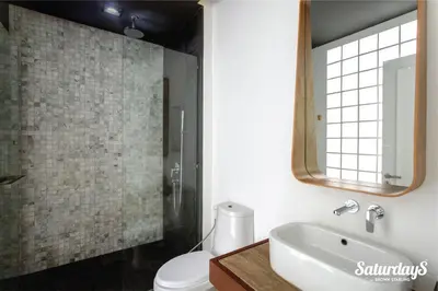 a bathroom with a sink and a toilet and a mirror at Saturdays Residence - 1 Bedroom Service Apartment in Rawai Beach