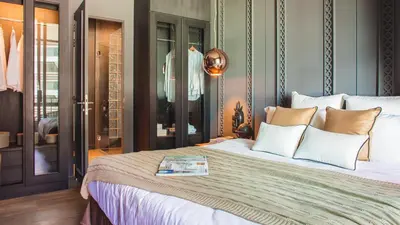 a bedroom with a large bed with white pillows at Saturdays Residence - 1 Bedroom Service Apartment in Rawai Beach