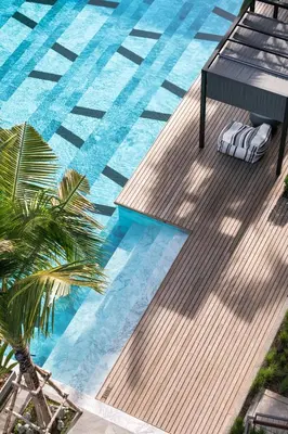 an overhead view of a swimming pool with a palm tree at Saturdays Residence - 2 Bedrooms Service Apartment in Rawai Beach