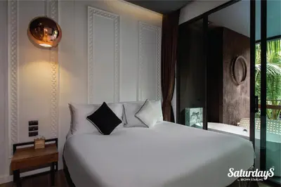 a bedroom with a large white bed and a window at Saturdays Residence - 2 Bedrooms Service Apartment in Rawai Beach