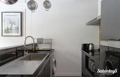 a kitchen with a sink and a counter top at Saturdays Residence - 2 Bedrooms Service Apartment in Rawai Beach