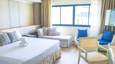 a hotel room with a bed and a living room at Hiran Residence in Patong Beach
