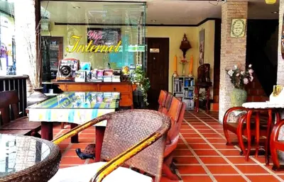 a restaurant with a table and chairs in front of a store at Andaman House SHA Plus in Patong Beach