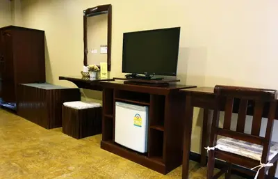 a room with a desk with a television on it at Andaman House SHA Plus in Patong Beach
