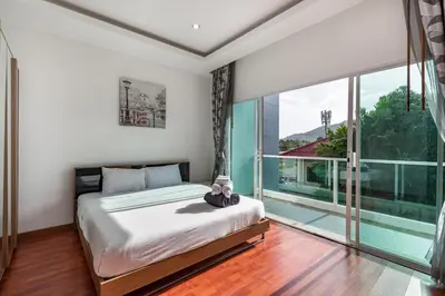 a bedroom with a bed and a large window at Trixie Town House 3 With Private Pool in Rawai Beach