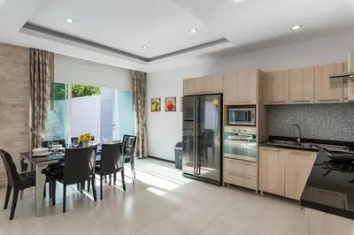 a kitchen and dining room with a table and chairs at Trixie Town House 3 With Private Pool in Rawai Beach