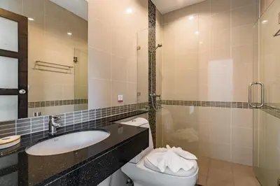 a bathroom with a sink and a toilet and a mirror at Trixie Town House 3 With Private Pool in Rawai Beach