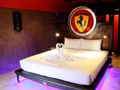 a bedroom with a white bed with a swan on it at Nicky's Handlebar in Patong Beach