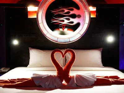 two flamingos in a bed in front of a mirror at Nicky's Handlebar in Patong Beach
