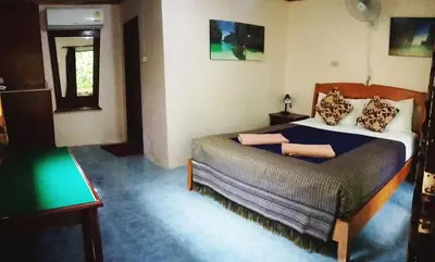 a bedroom with a large bed in a room at Anawin Bungalows in Ao Nang Beach