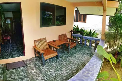 a patio with chairs and a table on a house at Anawin Bungalows in Ao Nang Beach