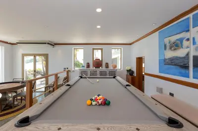 a pool table in a living room at Kalim Beach House - Private Beach & Pool in Patong Beach
