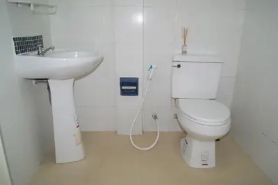 a bathroom with a toilet and a sink at Pineapple Guesthouse in Karon Beach