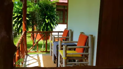 two chairs and a table on a porch at Krabi Discovery Resort in Tha Lane Bay