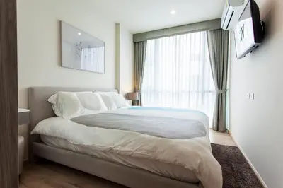 a bedroom with a large bed and a window at Phuket Town 1 Bedroom Condo Luxury Facilities, The Base Downtown in Phuket Town