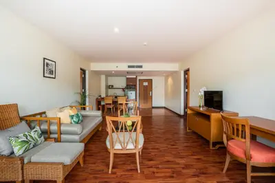 a living room with a couch and a table at Naithonburi Beach Resort - SHA Extra Plus in Nai Thon Beach