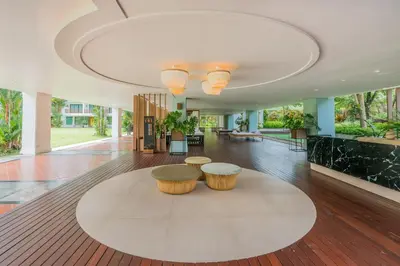 a lobby with two stools in the middle of a room at Naithonburi Beach Resort - SHA Extra Plus in Nai Thon Beach