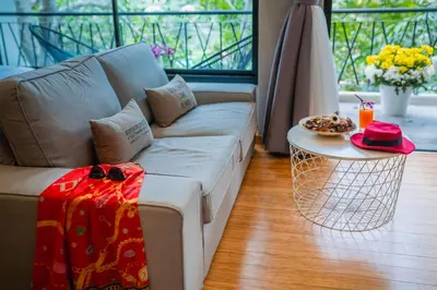 a living room with a couch and a table at The Woods Natural Park Resort Phuket in Kamala Beach