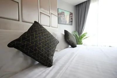 a bedroom with two pillows on a bed at 6-Ave Surin Apartment in Surin Beach