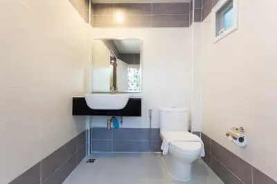 a bathroom with a toilet and a sink at Sandy House Rawai in Rawai Beach