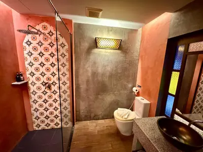 a bathroom with a shower with a toilet and a sink at De Cozé Hotel in Patong Beach