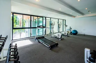 a gym with several treadmills and exercise bikes at The Unity Patong in Patong Beach