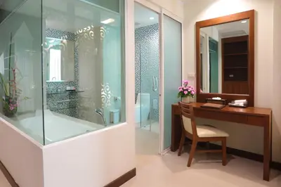 a bathroom with a desk and a shower with a tub at A2 Pool Resort - SHA Plus in Phuket Town