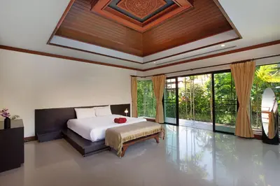 a bedroom with a large bed and large windows at Tropical Living at 3BR Pool Villa Bianca, Baan Bua Luxury Estate, Nai Harn Beach in Rawai Beach