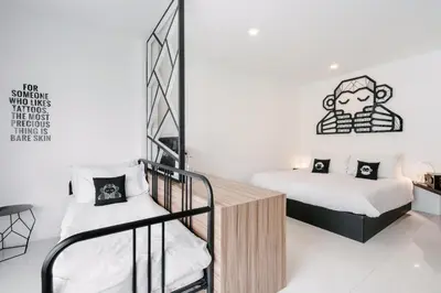 a bedroom with two bunk beds and a staircase at Blu Monkey Phi Phi Island in Phi Phi Don