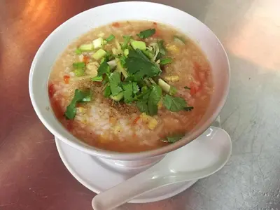 a bowl of soup on a plate with a spoon at Krabi Villa Phu Khao Private Resort in Klong Muang Beach