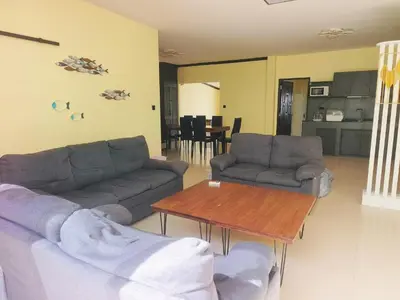 a living room with two couches and a table at Thai family rawai Swimming pool villa Hotel in Rawai Beach