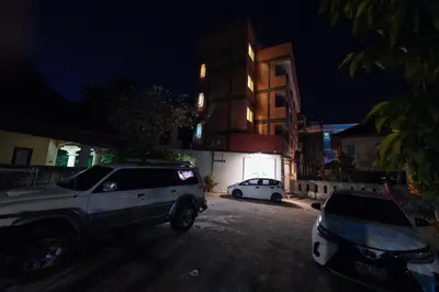 a white suv parked in a parking lot at night at Baan Kamala Backpacker in Kamala Beach