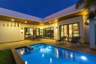 a villa with a swimming pool at night at West facing 3br Boutique Pool Villa by Intira Villas in Rawai Beach