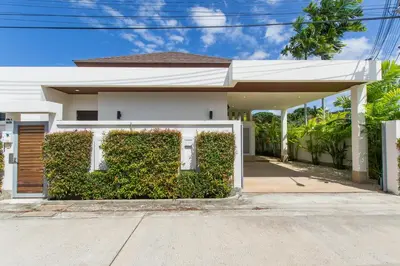 a white house with a hedge in front of it at West facing 3br Boutique Pool Villa by Intira Villas in Rawai Beach