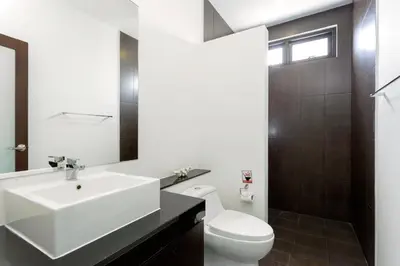 a bathroom with a white sink and a toilet at Big Buddha View 3br Pool Villa by Intira Villas in Rawai Beach
