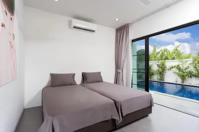 a bedroom with a bed and a large window at Large 3br Boutique Villa with big Pool by Intira Villas in Rawai Beach