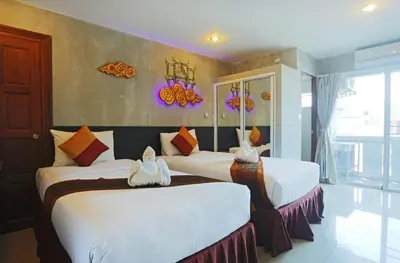 a bedroom with two beds in a room at Baan Kamala Fantasea Hotel in Kamala Beach