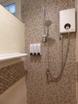 a shower stall in a bathroom with a shower at The Krabi Forest Homestay in Ao Nang Beach