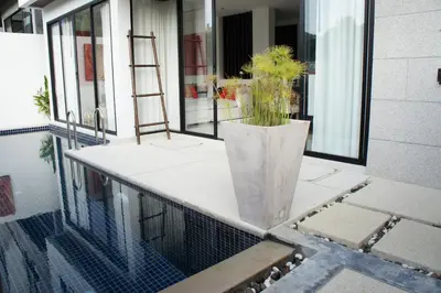 a vase with a plant in it on a balcony at By The Lake Villas in Nai Harn Beach