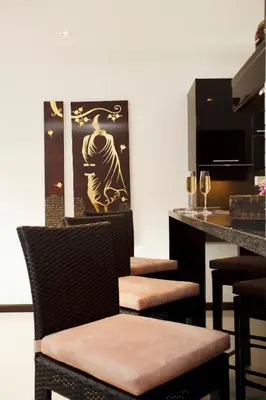 a bar with two chairs and a counter with wine glasses at By The Lake Villas in Nai Harn Beach