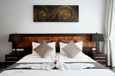 a hotel room with two beds with white towels at By The Lake Villas in Nai Harn Beach
