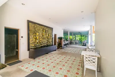 a living room with a large painting on the wall at The Palm at Veloche Group by Lofty in Karon Beach
