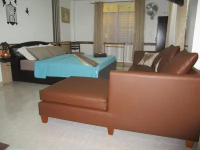 a living room with a couch and a bed at Similan Hotel in Bang Tao Beach