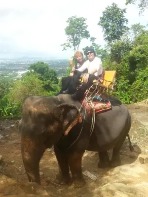 a group of people riding on the back of an elephant at Similan Hotel in Bang Tao Beach