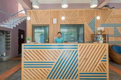a woman standing behind a counter in a store at Amarin Hotel Patong in Patong Beach