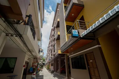 an alley way with buildings on both sides at Amarin Hotel Patong in Patong Beach